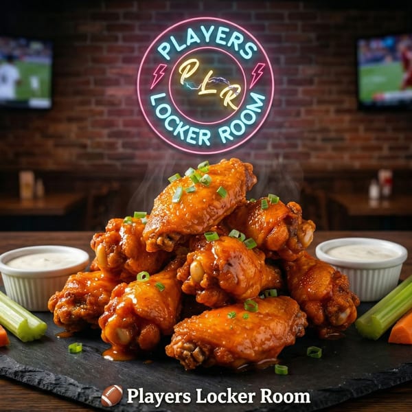 Steaming buffalo wings with ranch, celery, and carrots under a neon "Players Locker Room" sign.